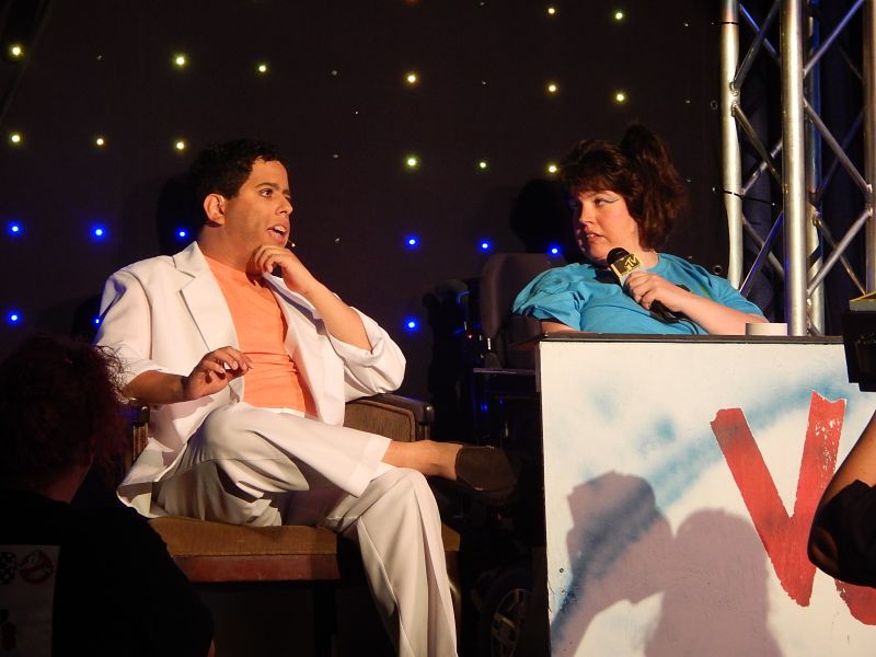 image of two people on stage sitting and talking